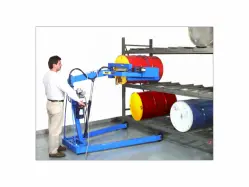 Man operating a Omni-lift drum racker/stacker that is removing a red drum from a large storage rack.