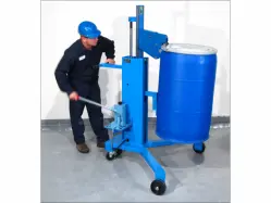 Man operating a drum transporter to raise an upright blue drum with a white lid.