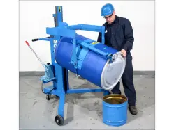 A person operating a large blue drum palletizer pourer, dumping a substance into a smaller bucket